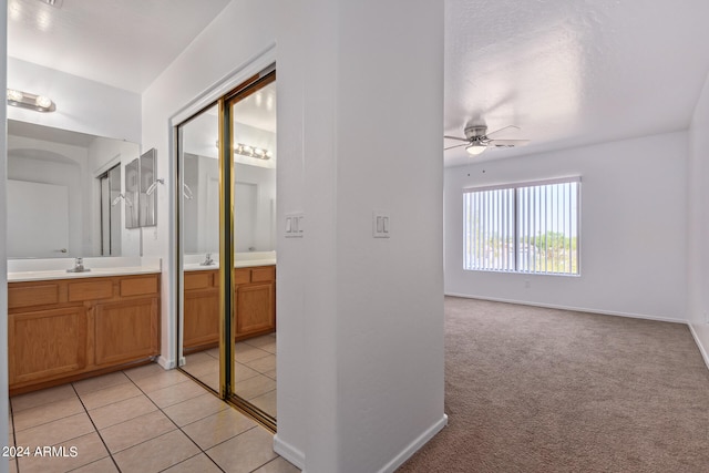 bathroom with ceiling fan, vanity, and tile patterned floors