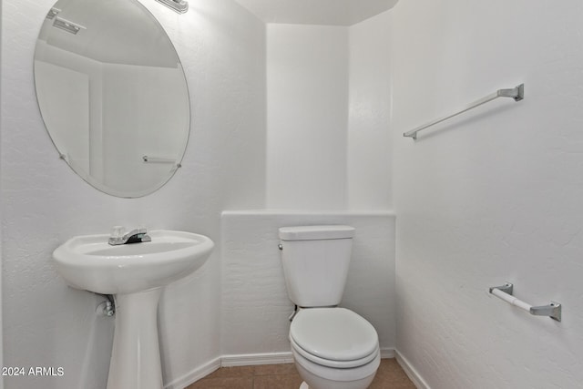 bathroom with tile patterned flooring, sink, and toilet