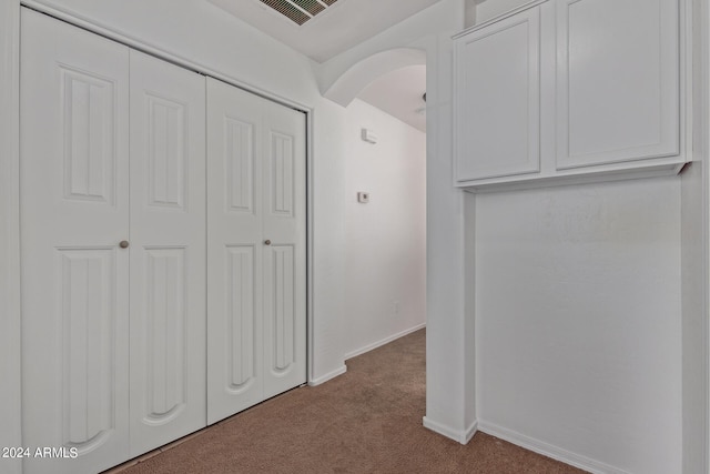 corridor with light colored carpet