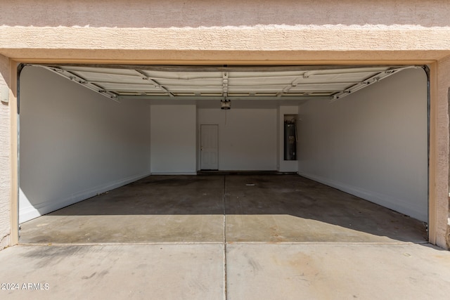 garage with water heater and a garage door opener