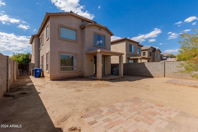 rear view of property featuring a patio