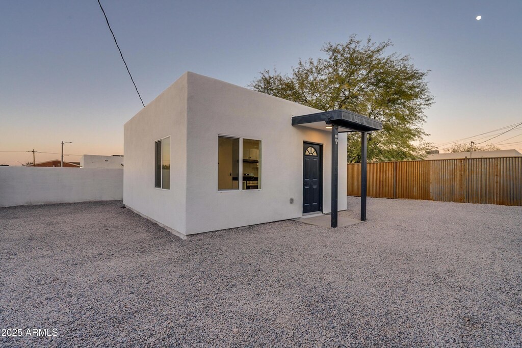 210 E Elm St, Tucson, AZ 85705 - back of house featuring stucco siding and a fenced backyard