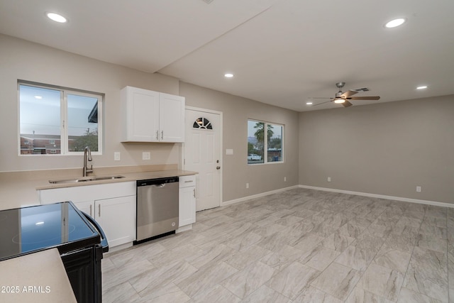 kitchen featuring sink, a wealth of natural light, stainless steel dishwasher, and white cabinets