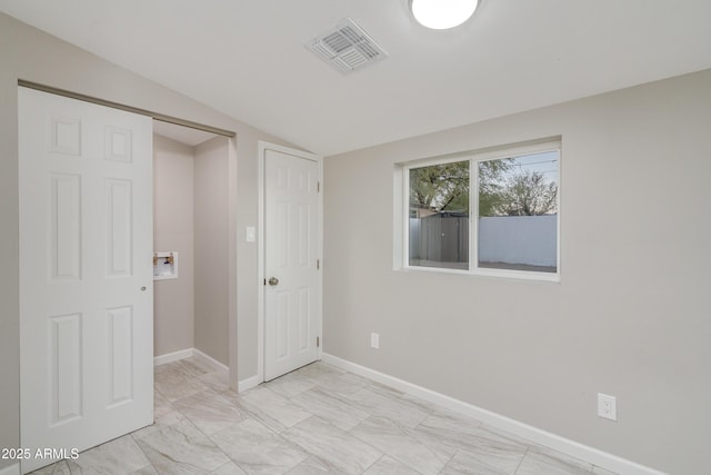 unfurnished room with lofted ceiling