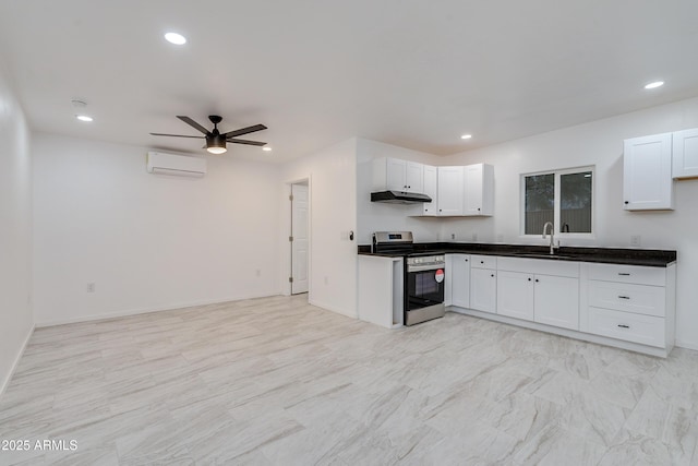 kitchen with white cabinetry, a wall mounted air conditioner, sink, and stainless steel stove