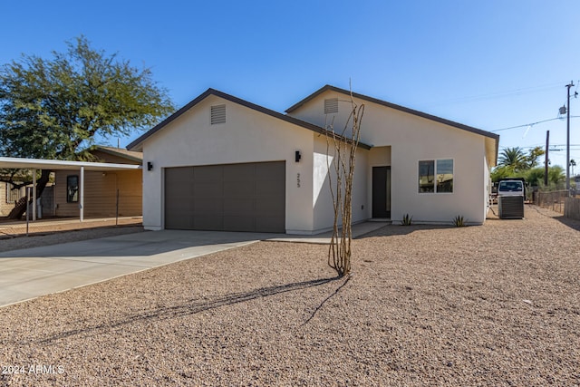 view of front of house with a garage and a carport