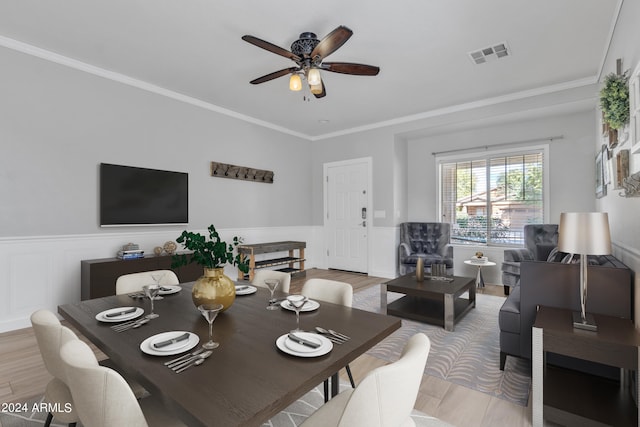 dining area featuring light hardwood / wood-style floors, crown molding, and ceiling fan