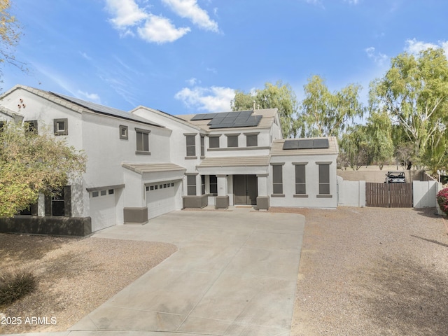 view of front of property featuring a garage, fence, driveway, a gate, and stucco siding