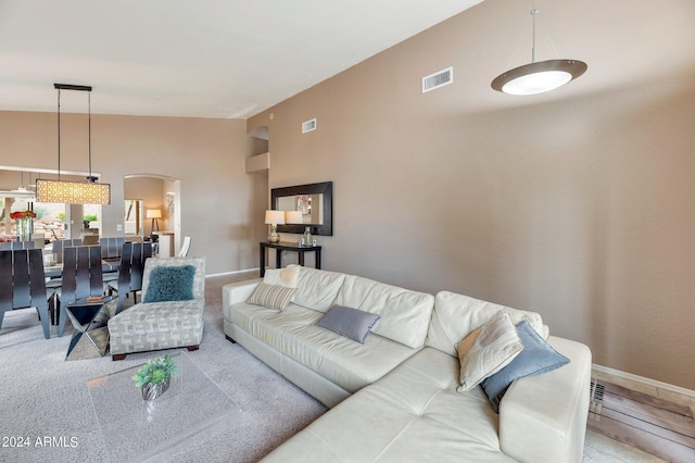 living room with high vaulted ceiling