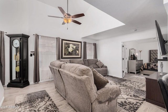 living room with light hardwood / wood-style flooring and ceiling fan