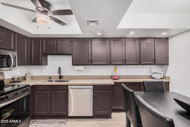 kitchen with sink, dark brown cabinets, ceiling fan, and stainless steel appliances