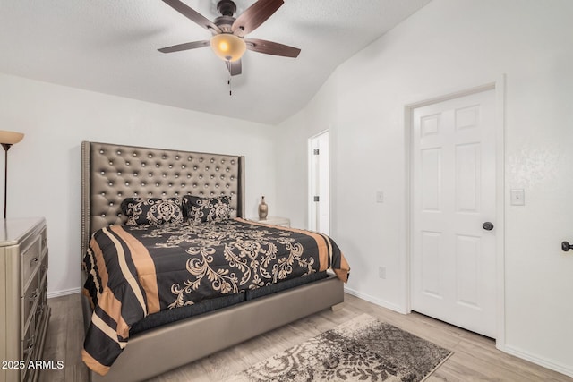 bedroom featuring lofted ceiling, light hardwood / wood-style floors, and ceiling fan