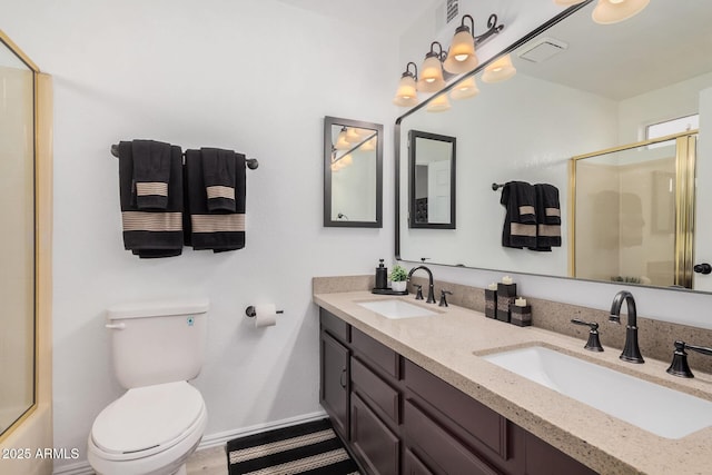 full bathroom with bath / shower combo with glass door, toilet, and vanity