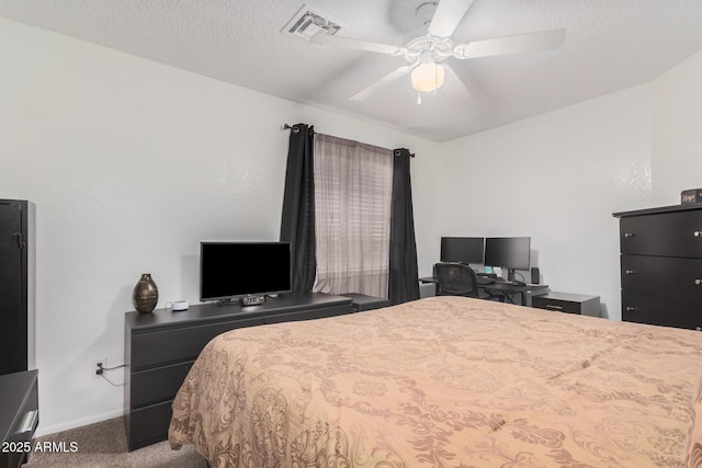 carpeted bedroom with a textured ceiling and ceiling fan