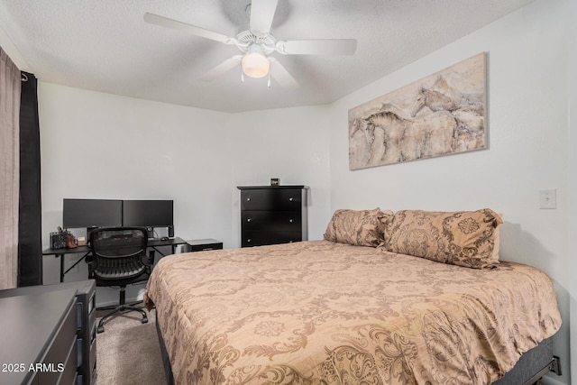 bedroom featuring ceiling fan, a textured ceiling, and carpet floors