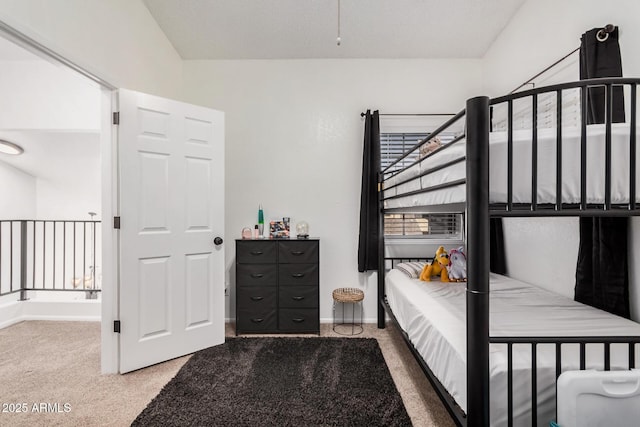 carpeted bedroom featuring lofted ceiling