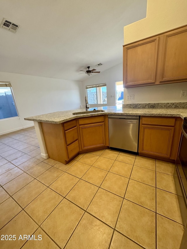 kitchen with light tile patterned floors, ceiling fan, dishwasher, and kitchen peninsula