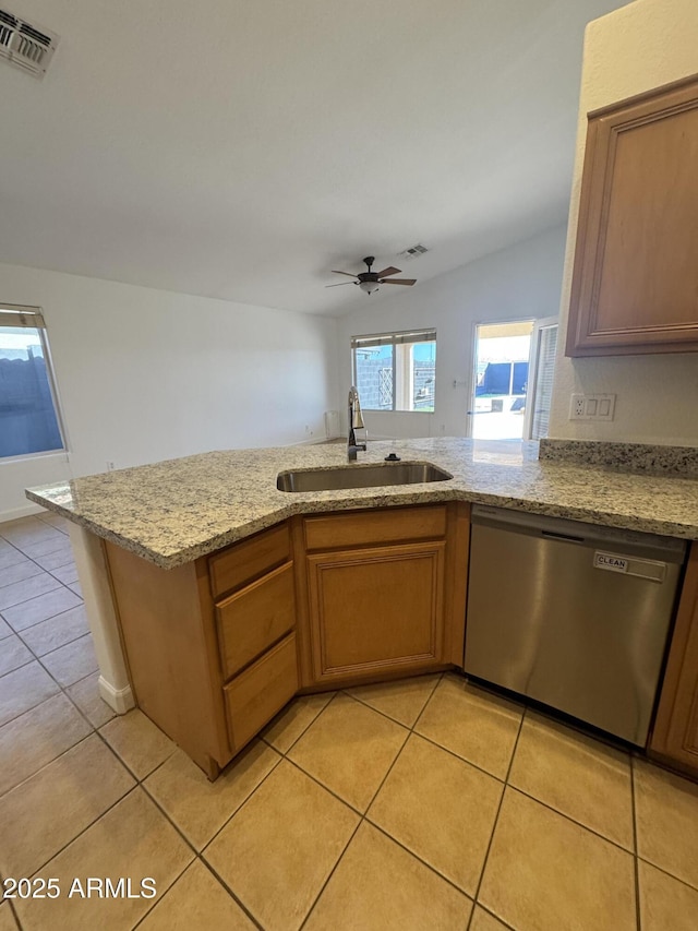 kitchen featuring stainless steel dishwasher, light tile patterned flooring, sink, and ceiling fan