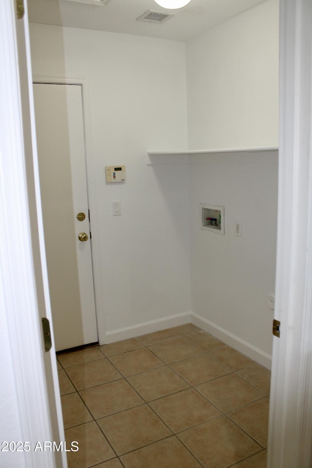 laundry area featuring hookup for a washing machine and light tile patterned floors