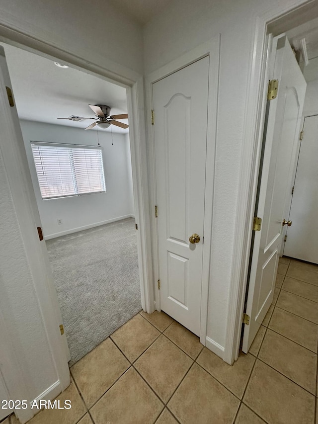 hallway with light colored carpet