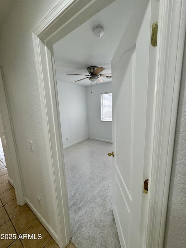 hall with light colored carpet