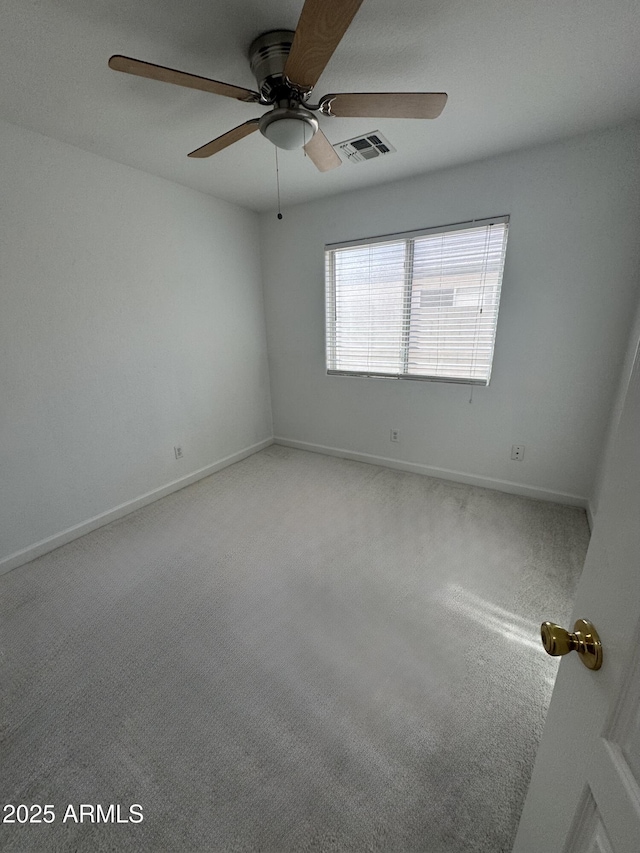 spare room featuring carpet floors and ceiling fan