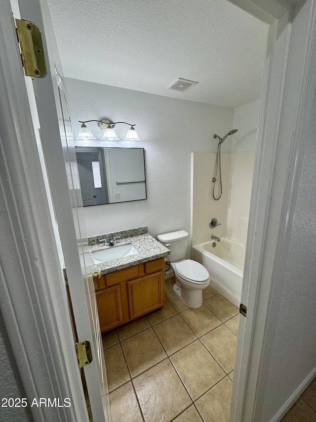 full bathroom with a textured ceiling, toilet, vanity, and shower / bath combination