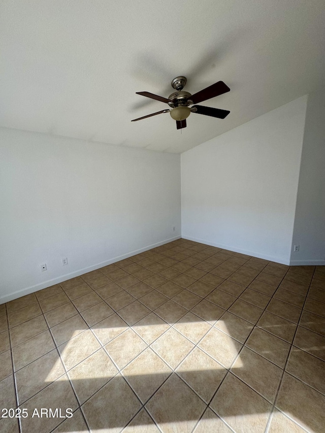 spare room featuring ceiling fan and light tile patterned floors