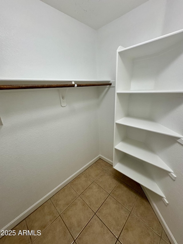 walk in closet featuring tile patterned flooring