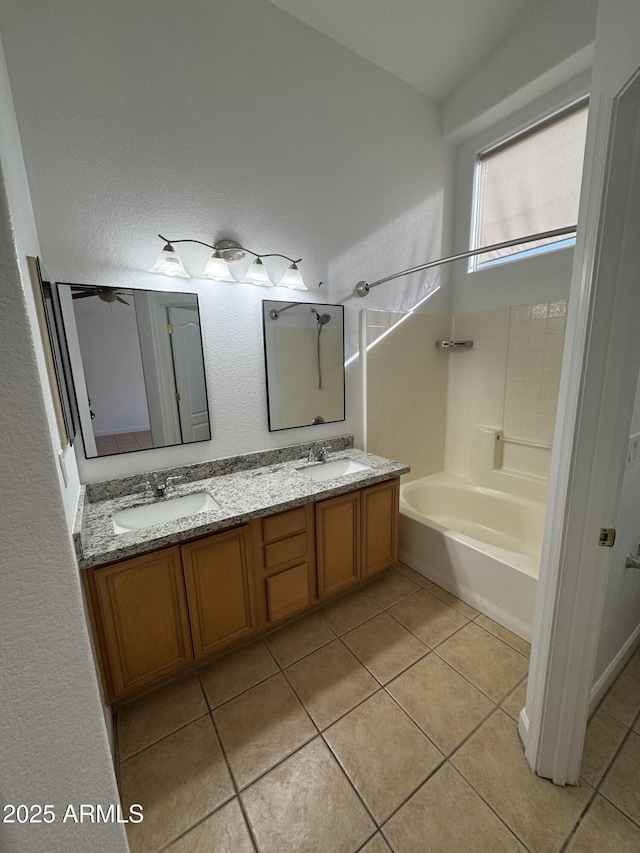 bathroom featuring tile patterned flooring, shower / bath combination, and vanity