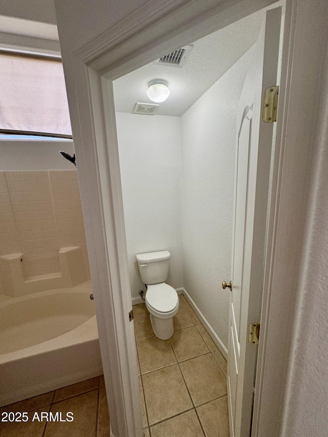 bathroom featuring tile patterned flooring and toilet