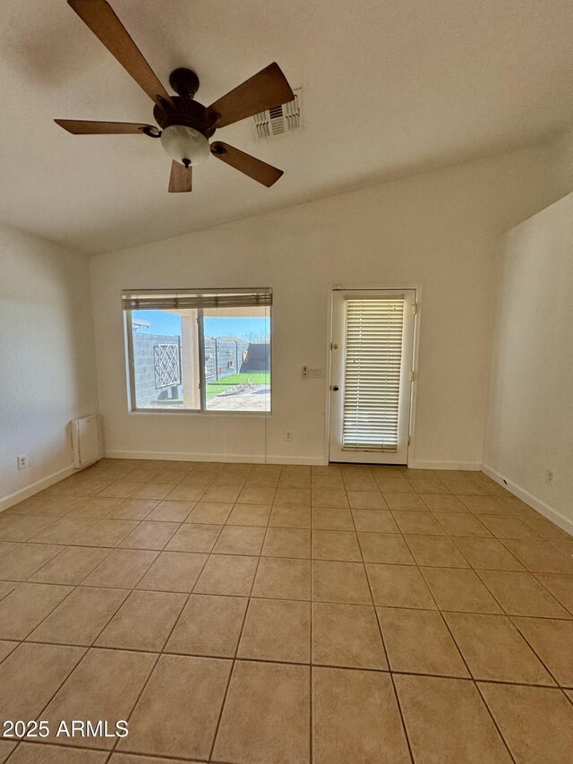 spare room featuring ceiling fan, lofted ceiling, and light tile patterned floors