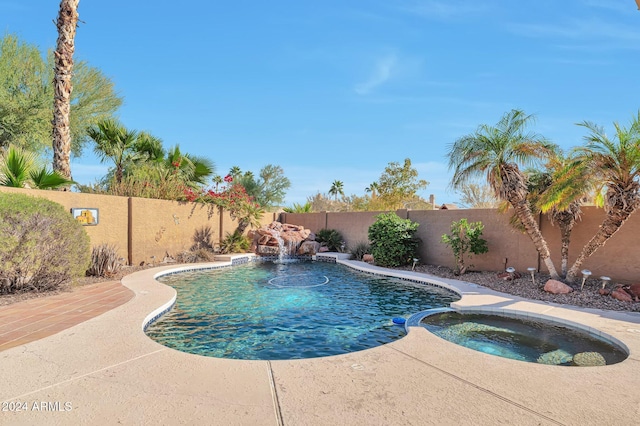 view of swimming pool featuring an in ground hot tub