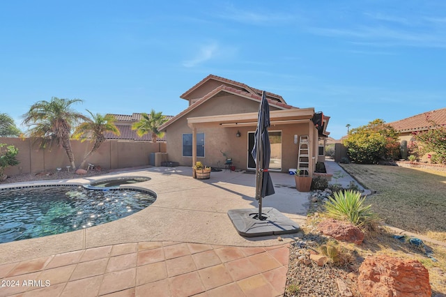 view of pool featuring a patio area, an in ground hot tub, and central AC