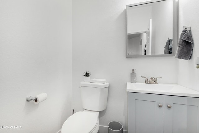 bathroom with toilet and vanity