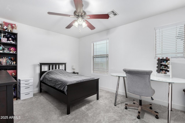 carpeted bedroom with visible vents, a ceiling fan, and baseboards