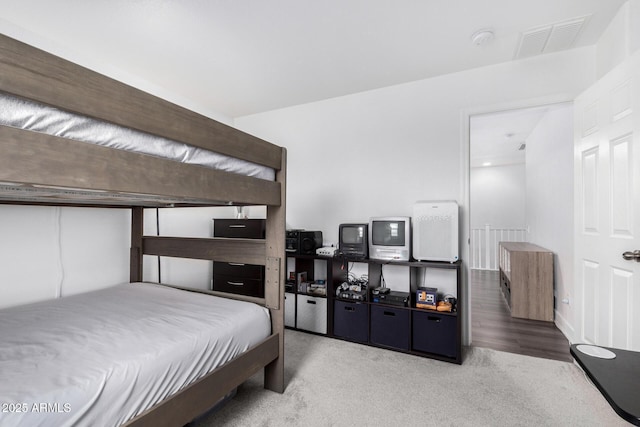 carpeted bedroom featuring visible vents