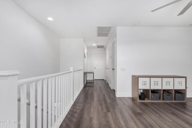 hallway featuring recessed lighting, wood finished floors, visible vents, and baseboards