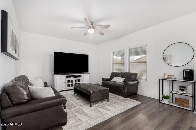 living room with baseboards, wood finished floors, and a ceiling fan