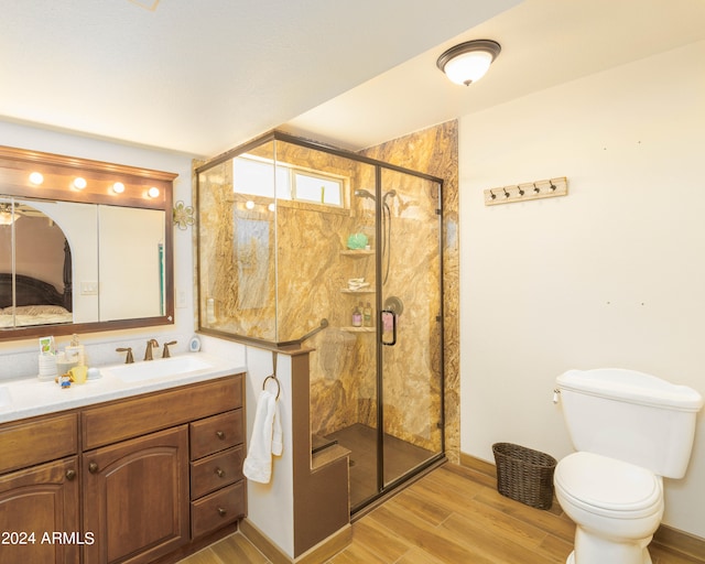 bathroom with vanity, toilet, wood-type flooring, and walk in shower