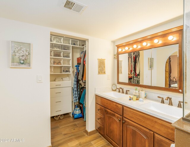 bathroom with vanity and wood-type flooring