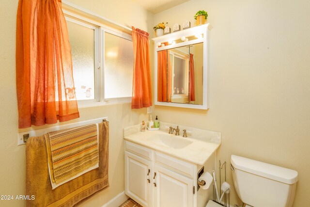 bathroom featuring toilet and vanity