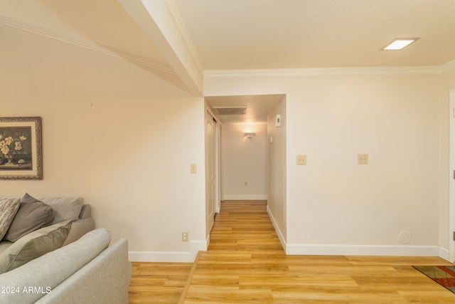 hall featuring light wood-type flooring and ornamental molding