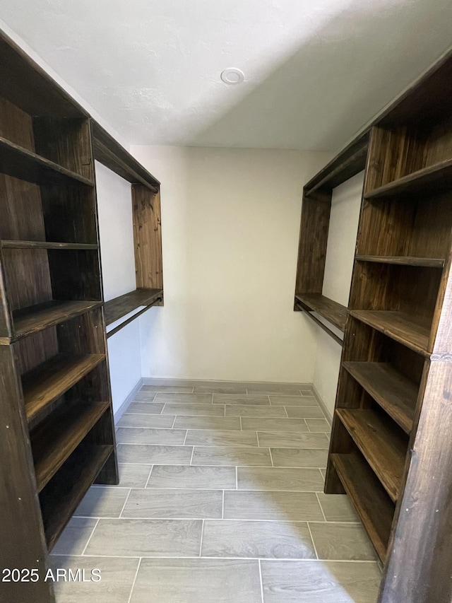 spacious closet with wood finish floors