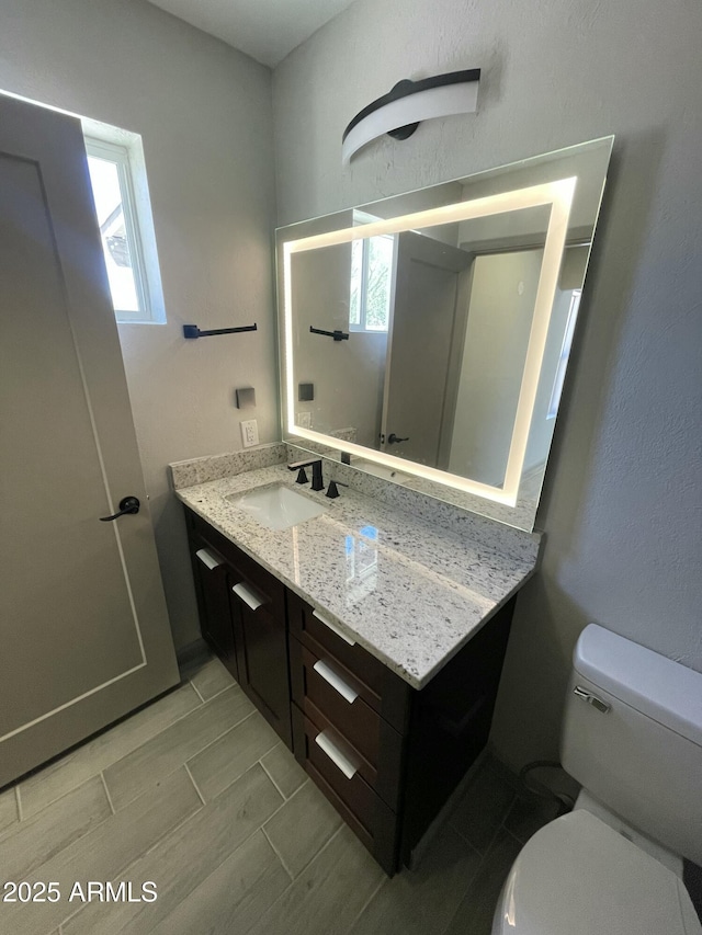 bathroom with vanity and toilet