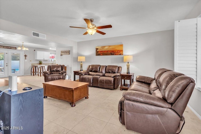 living room with light tile patterned floors, visible vents, baseboards, ceiling fan, and french doors