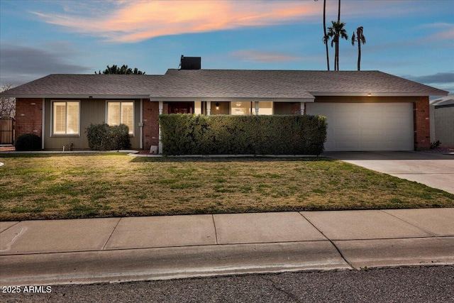 ranch-style house with a garage, driveway, a front lawn, and brick siding