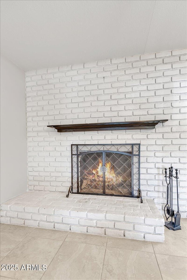 interior details featuring a fireplace and a textured ceiling