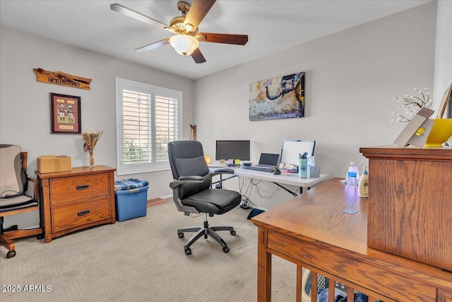 office area with a ceiling fan, light colored carpet, and baseboards