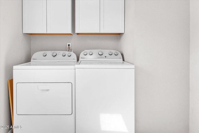 clothes washing area with cabinet space and washer and clothes dryer